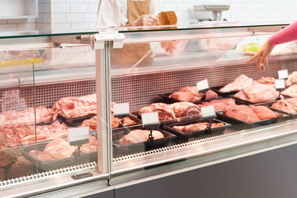 Senior butcher waiting for order.
